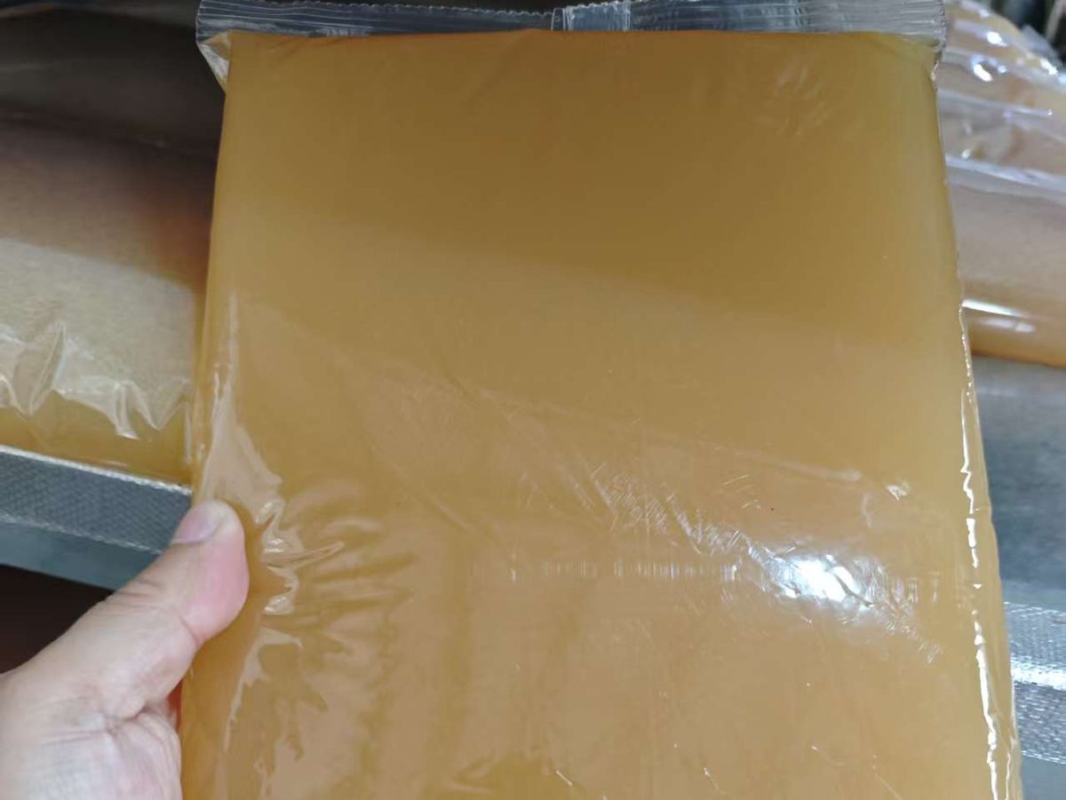 A sealed block of jelly glue held in the hand
